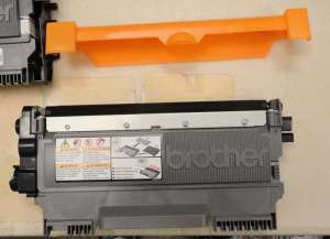Gently shake the new toner cartridge side to side, then remove the protective plastic